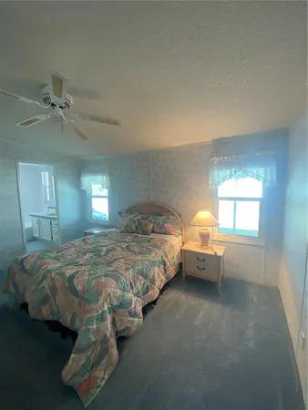 a bedroom with bed and window