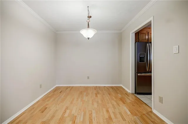 a view of a room with wooden floor and ceiling fan
