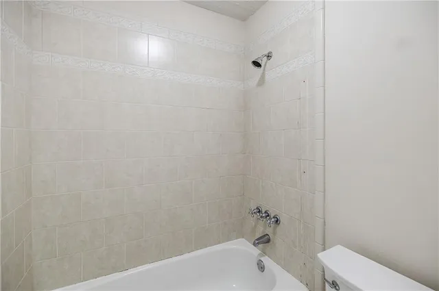 a bathroom with a bathtub and toilet