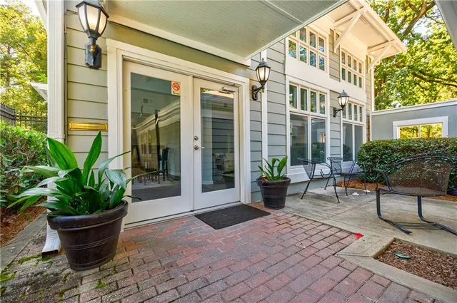 a lobby with furniture and potted plants