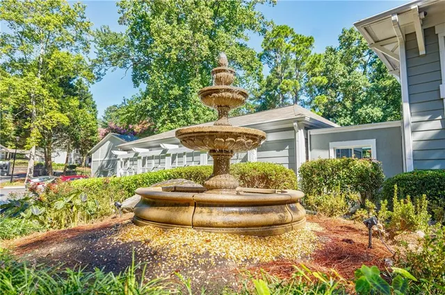 a front view of house with yard and trees around