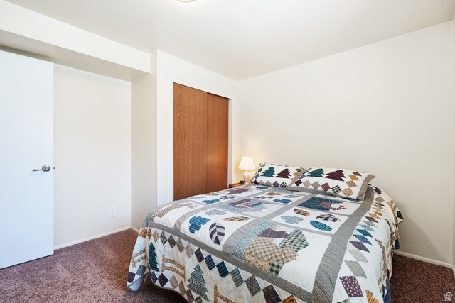 865 South 325 West Orem, UT 84058 - Photo 16 of 38 Carpeted bedroom featuring white painted walls and wood-finish sliding closet doors