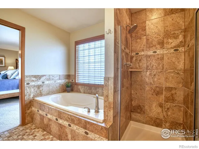 a bathroom with a tub and shower