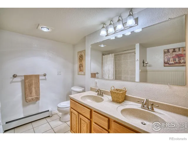 a bathroom with a sink a large mirror and a toilet