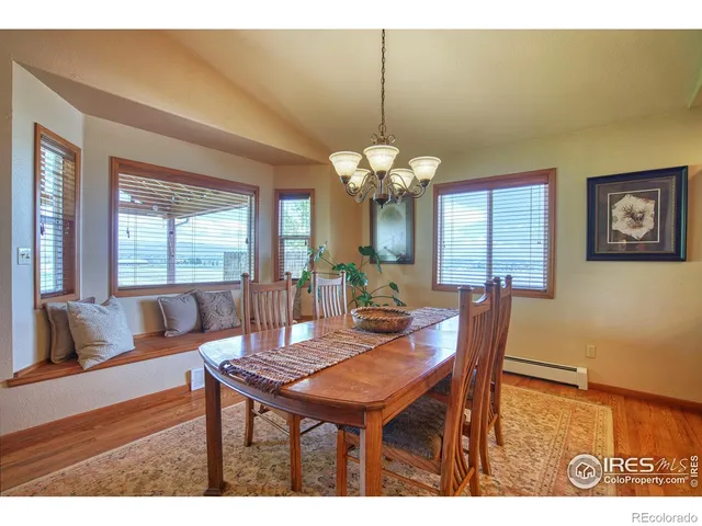a dining room with furniture a rug and a chandelier