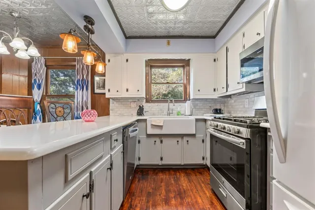 a kitchen with a sink stove and cabinets