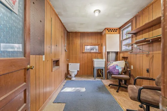 a living room with furniture a rug and a large window