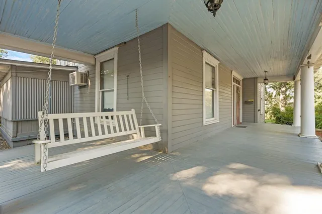 a view of a porch with wooden floor