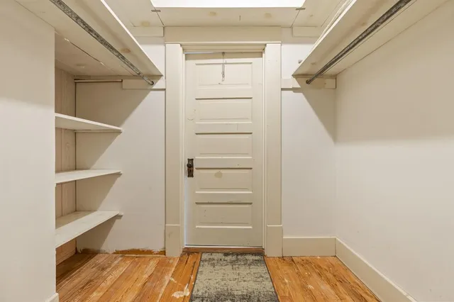 a view of walk in closet with empty racks