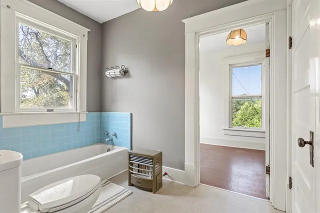 a bathroom with a bathtub sink and toilet