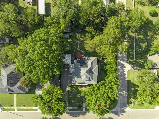 an aerial view of a house with a yard and potted plants