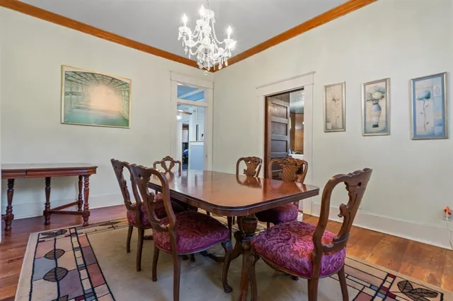 a view of a dining room with furniture and chandelier