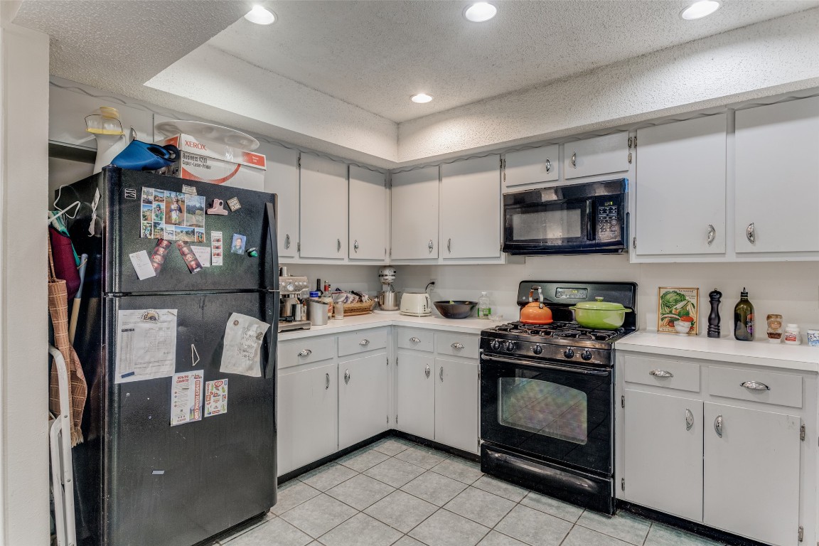 2713 Tether Trail Austin, TX 78704 - Photo 12 of 22 a kitchen with stainless steel appliances granite countertop a refrigerator a sink a stove top oven a counter space and cabinets