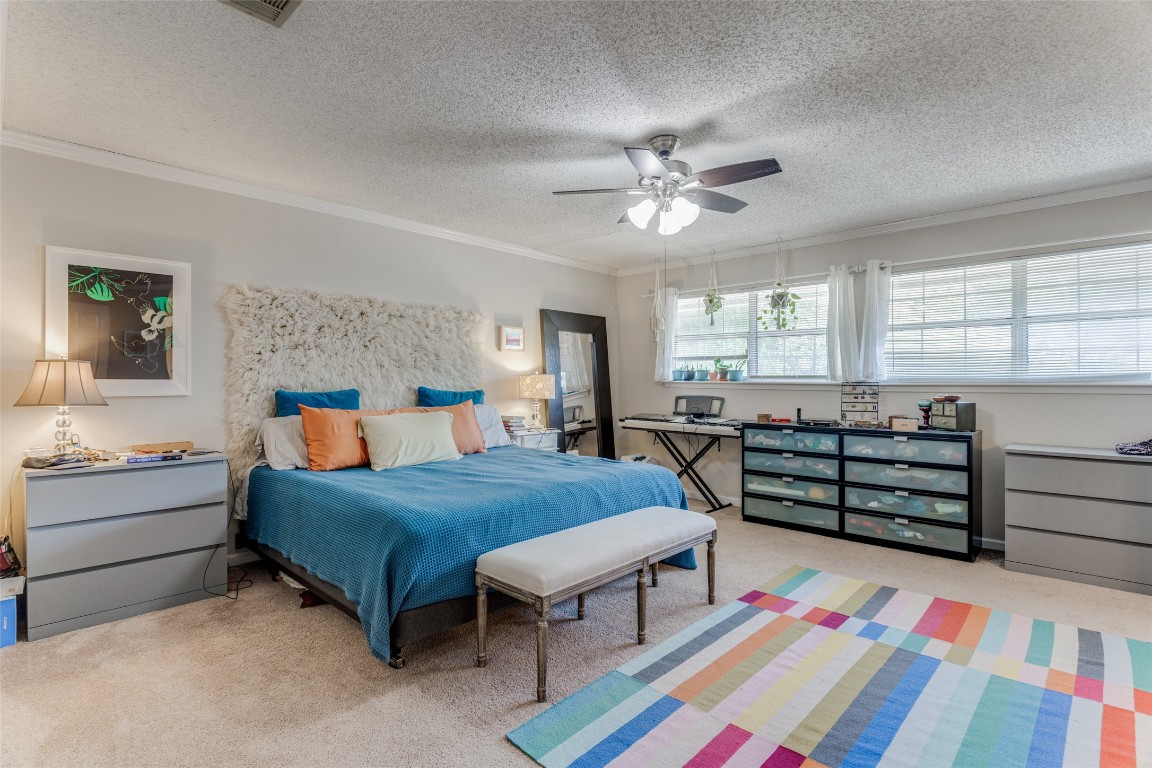 2713 Tether Trail Austin, TX 78704 - Photo 13 of 22 a bedroom with a bed and a chandelier