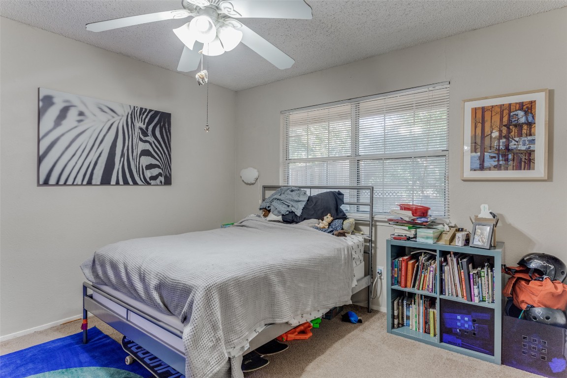 2713 Tether Trail Austin, TX 78704 - Photo 16 of 22 a bedroom with a bed and a book shelf