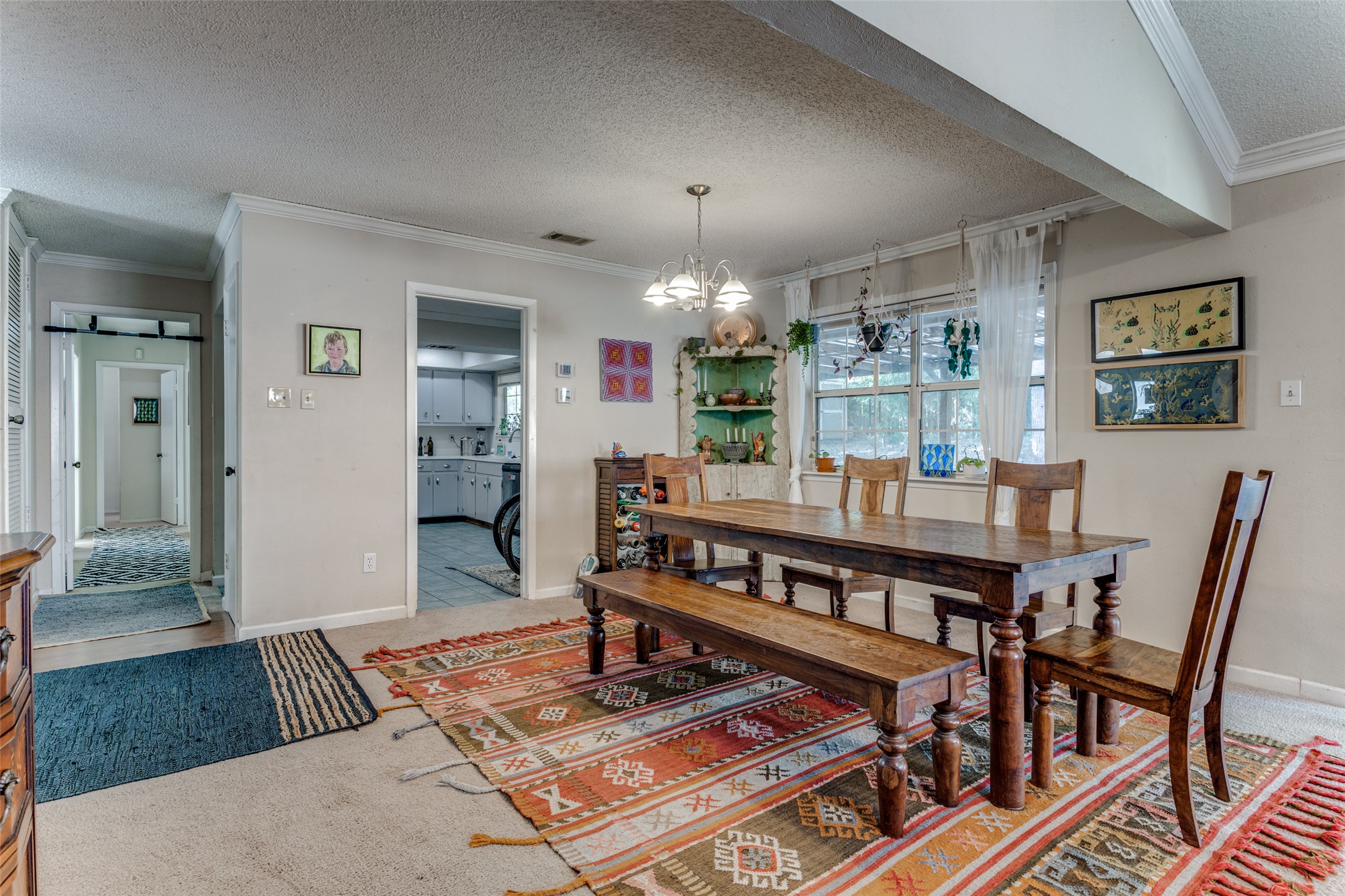 2713 Tether Trail Austin, TX 78704 - Photo 9 of 22 a living room with furniture a chandelier and a dining table