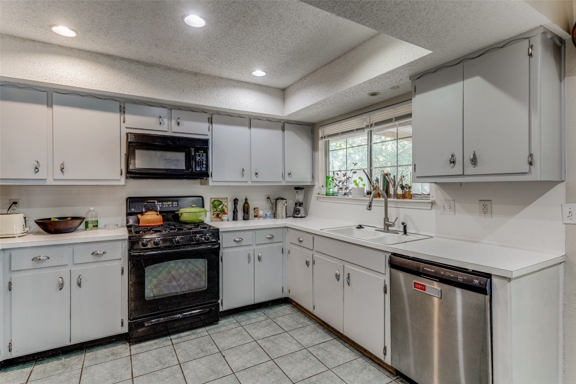 2713 Tether Trail Austin, TX 78704 - Photo 10 of 22 a kitchen with white cabinets appliances and a sink