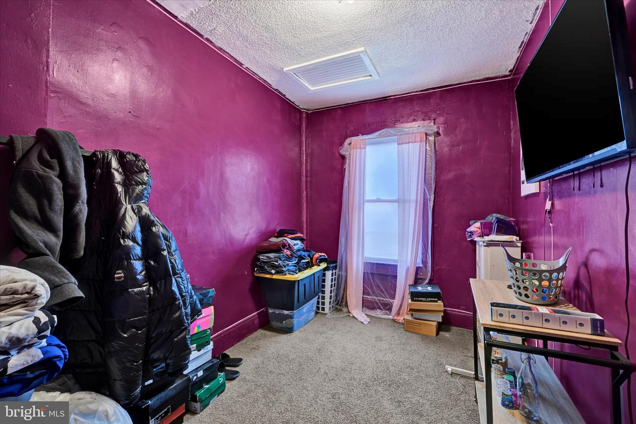3117 Baker Street Baltimore, MD 21216 - Photo 13 of 17 a room with furniture and clothes