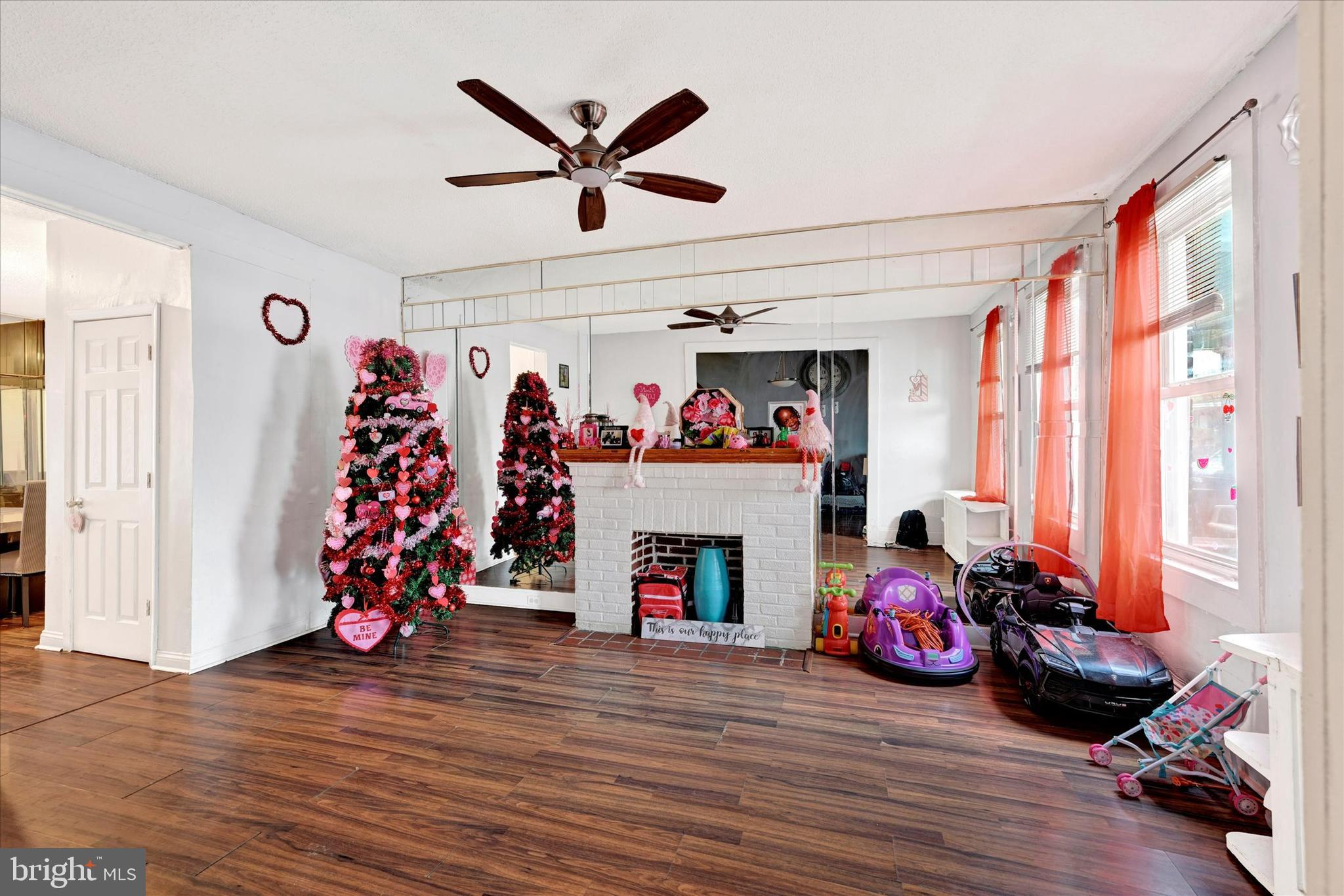 3117 Baker Street Baltimore, MD 21216 - Photo 2 of 17 a living room with furniture a fireplace and a window