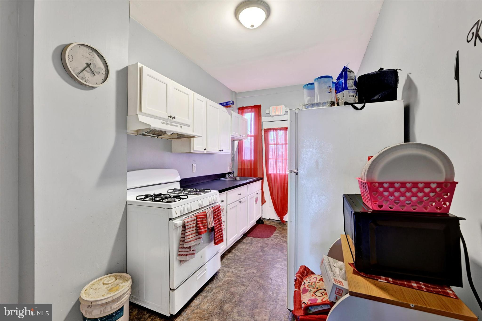 3117 Baker Street Baltimore, MD 21216 - Photo 7 of 17 a view of a kitchen with appliances and cabinets