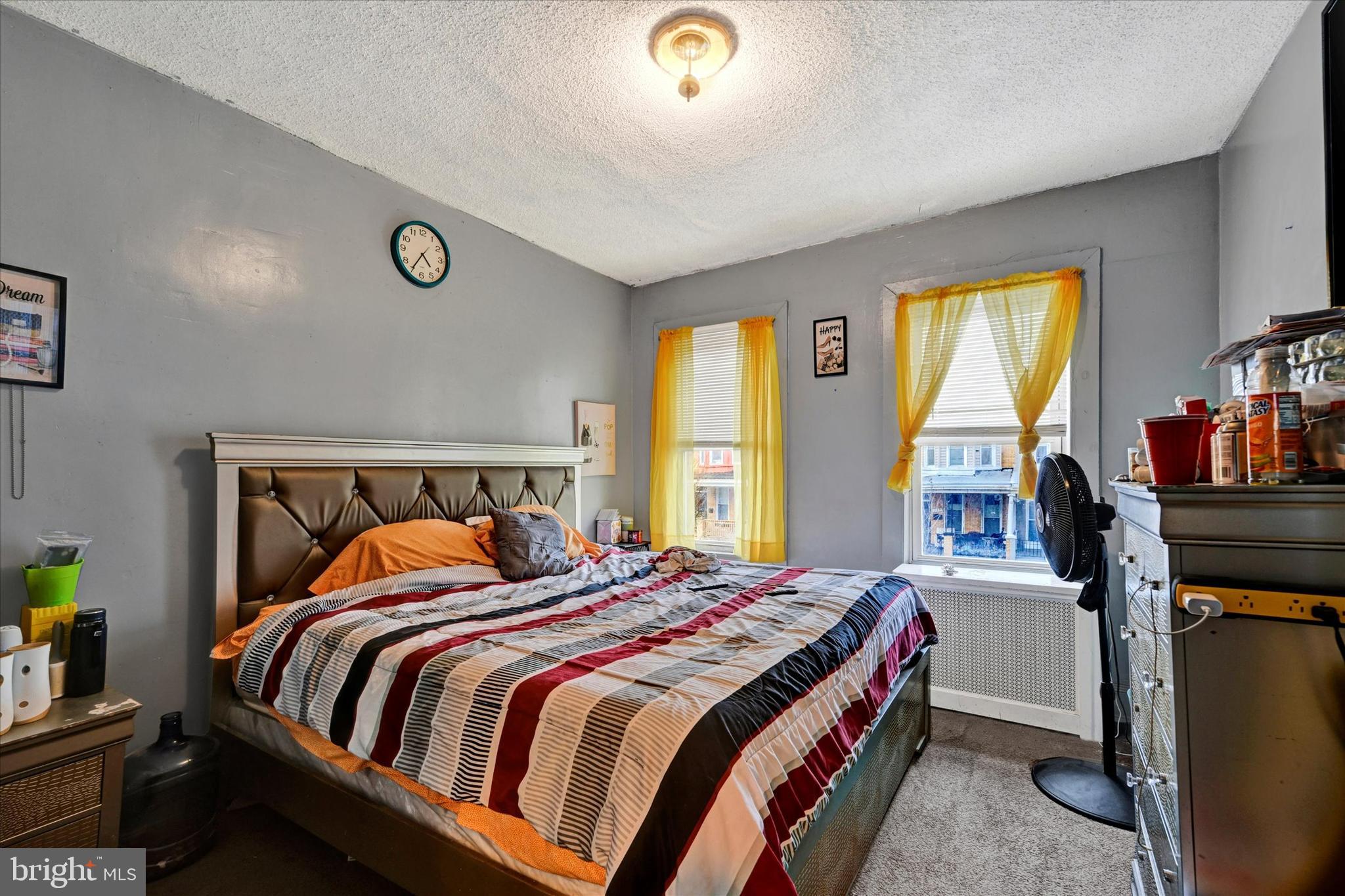 3117 Baker Street Baltimore, MD 21216 - Photo 10 of 17 a bedroom with a bed and a bookshelf