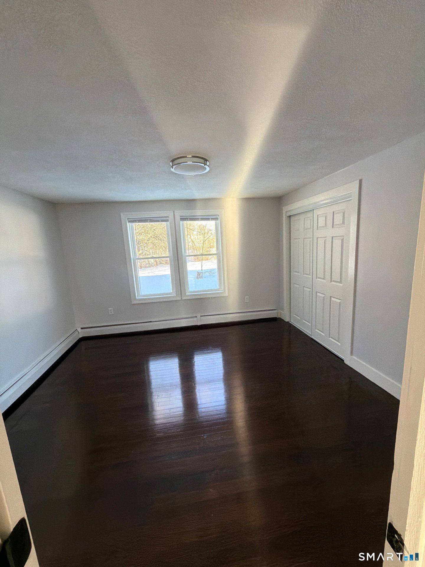 610 Ives Row Cheshire, CT 06410 - Photo 15 of 23 a view of an empty room with wooden floor and a window