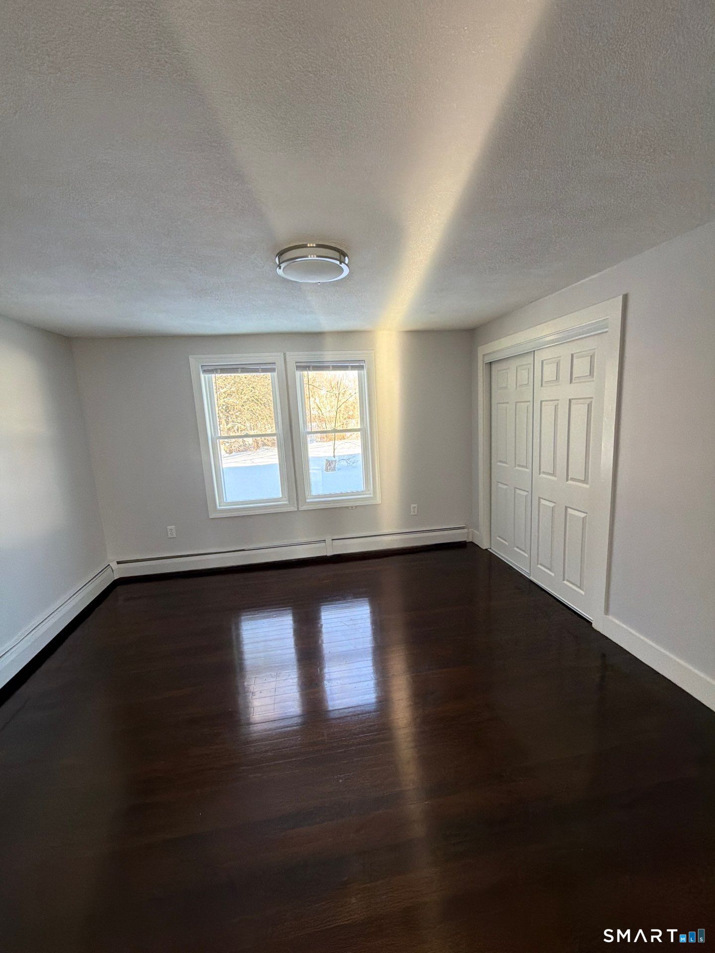 610 Ives Row Cheshire, CT 06410 - Photo 20 of 23 a view of an empty room with wooden floor and a window