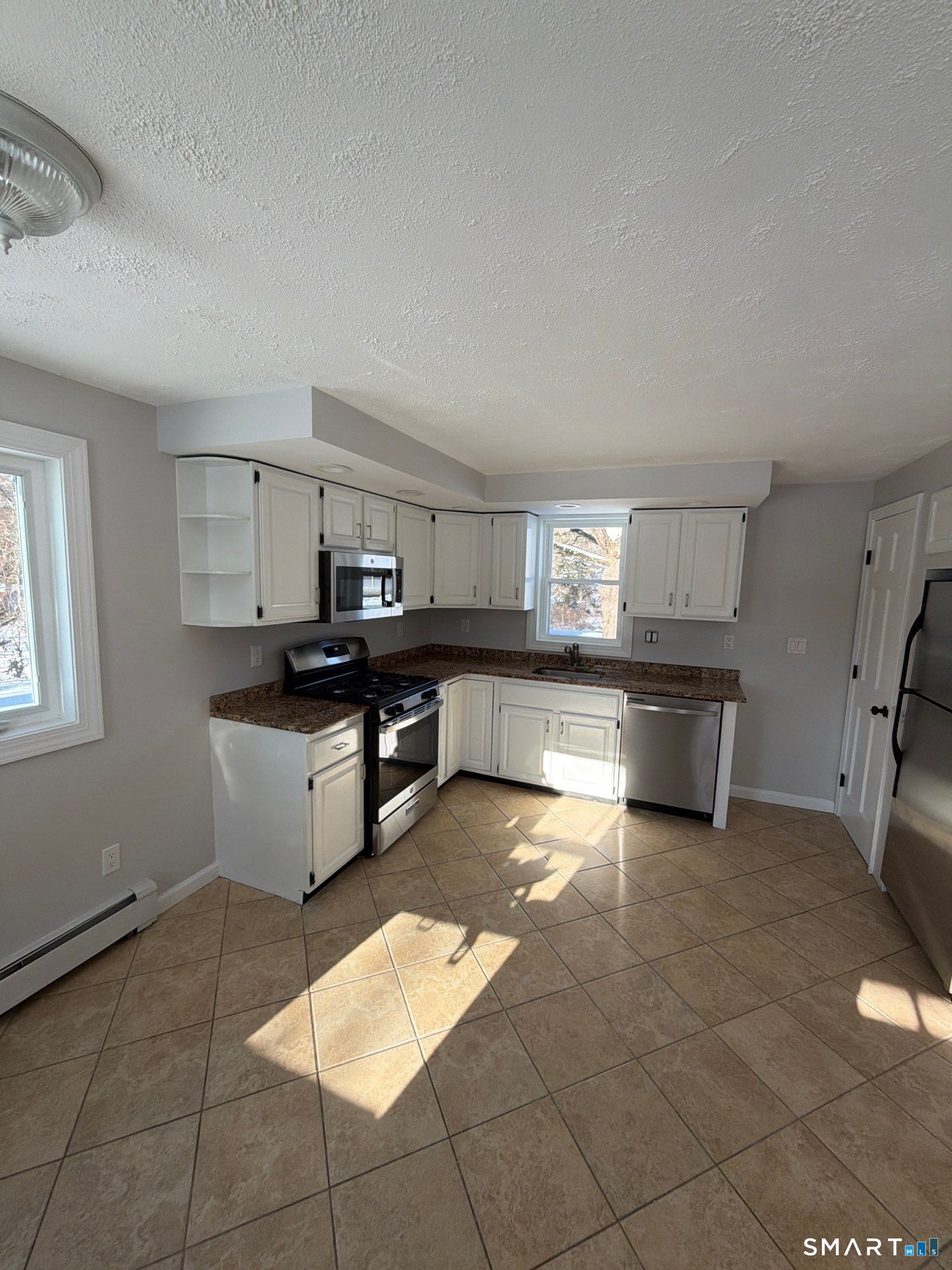 610 Ives Row Cheshire, CT 06410 - Photo 5 of 23 a kitchen with stainless steel appliances kitchen island granite countertop a stove top oven a sink a counter space and cabinets