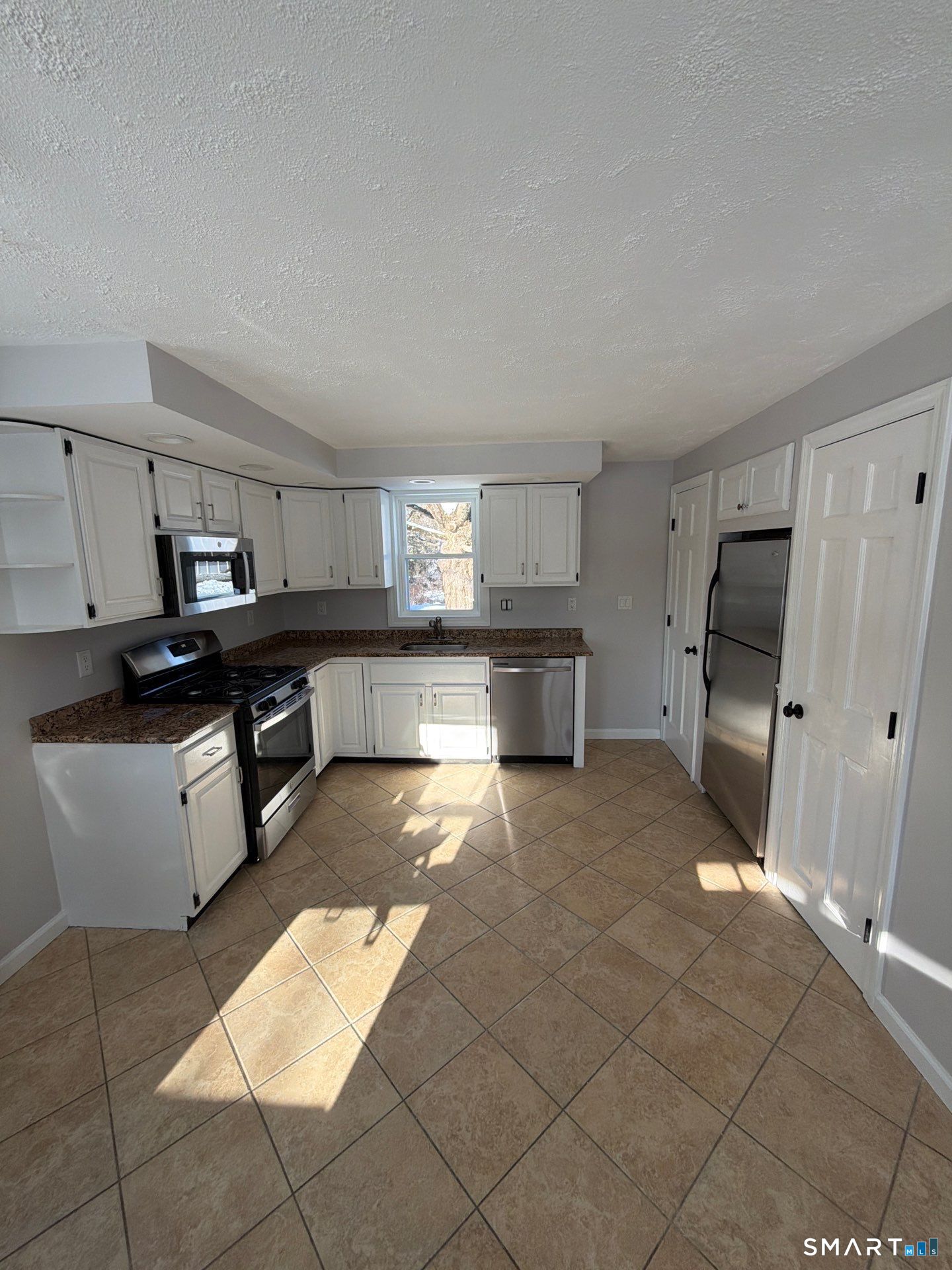 610 Ives Row Cheshire, CT 06410 - Photo 6 of 23 a large kitchen with cabinets and a stove