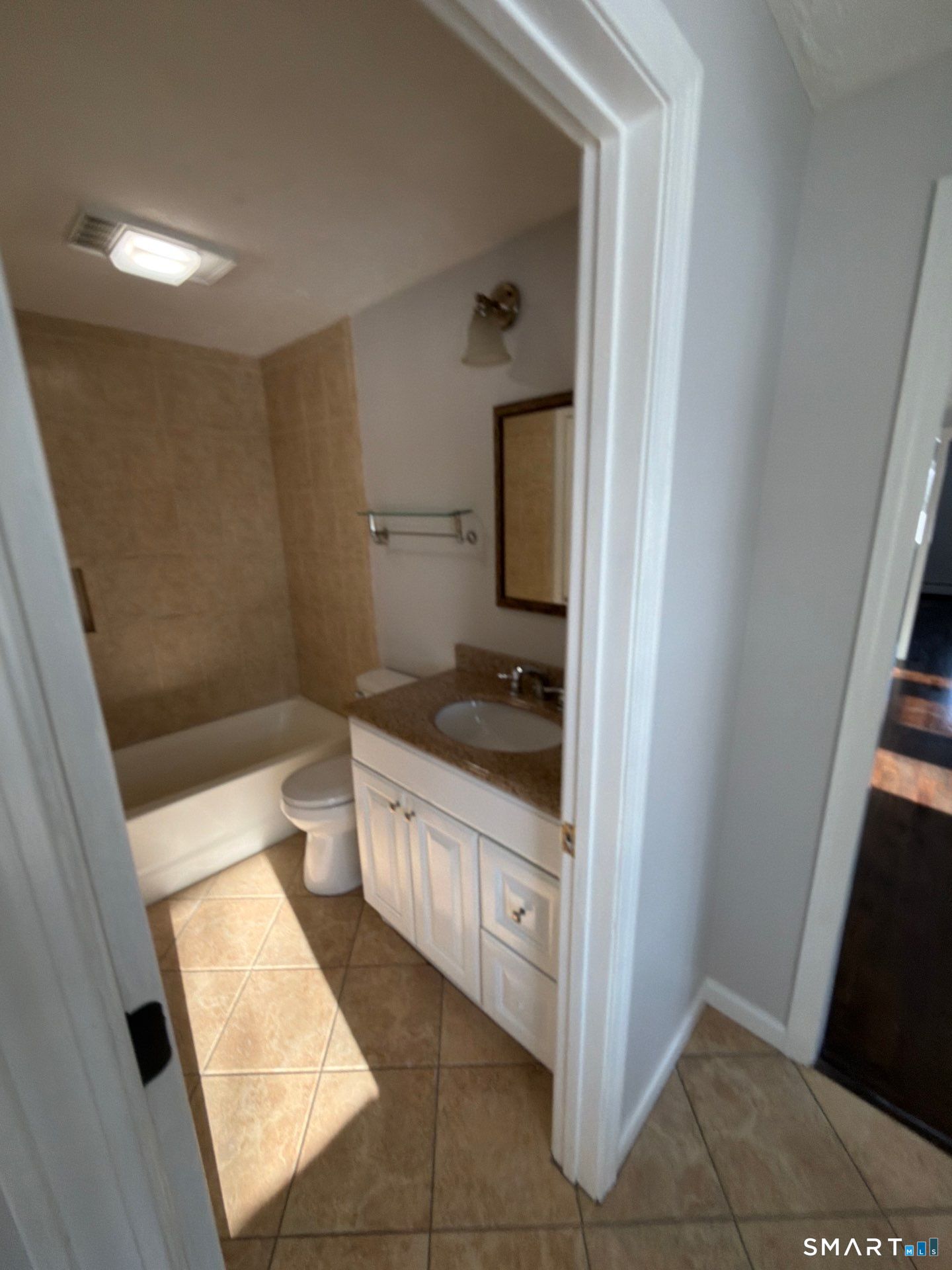 610 Ives Row Cheshire, CT 06410 - Photo 9 of 23 a bathroom with a granite countertop sink a toilet and a mirror