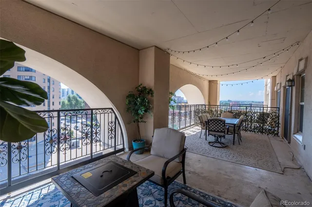 a view of a chairs and table in the balcony