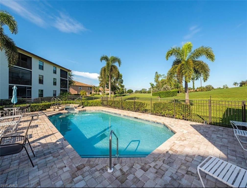 605 Augusta Boulevard, Unit 4 Naples, FL 34113 - Photo 11 of 14 a view of a swimming pool with a lounge chairs