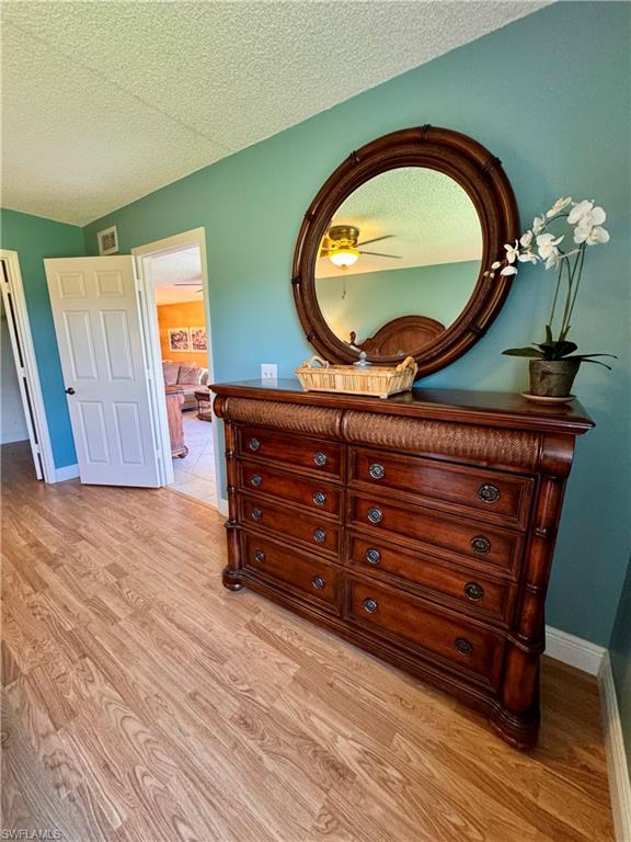 605 Augusta Boulevard, Unit 4 Naples, FL 34113 - Photo 5 of 14 a room with furniture and a mirror