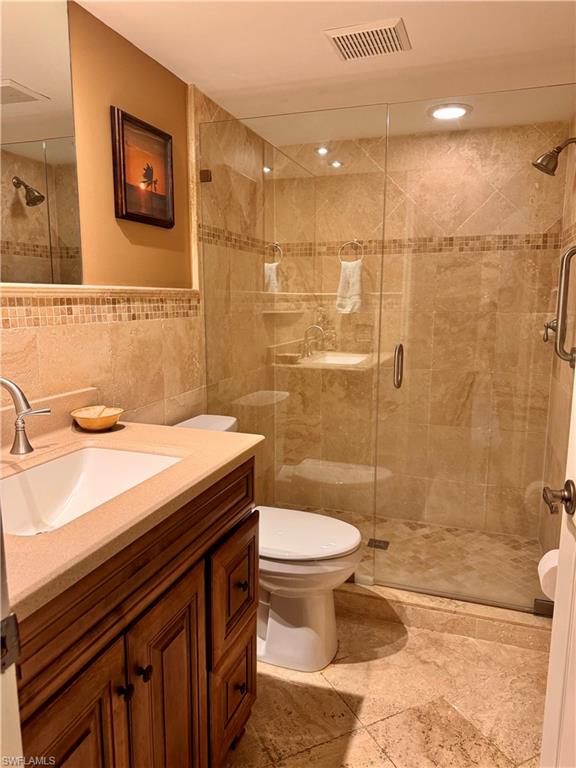 605 Augusta Boulevard, Unit 4 Naples, FL 34113 - Photo 7 of 14 a bathroom with a sink a toilet and shower
