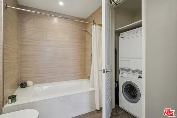 a bathroom with a granite countertop toilet sink and mirror