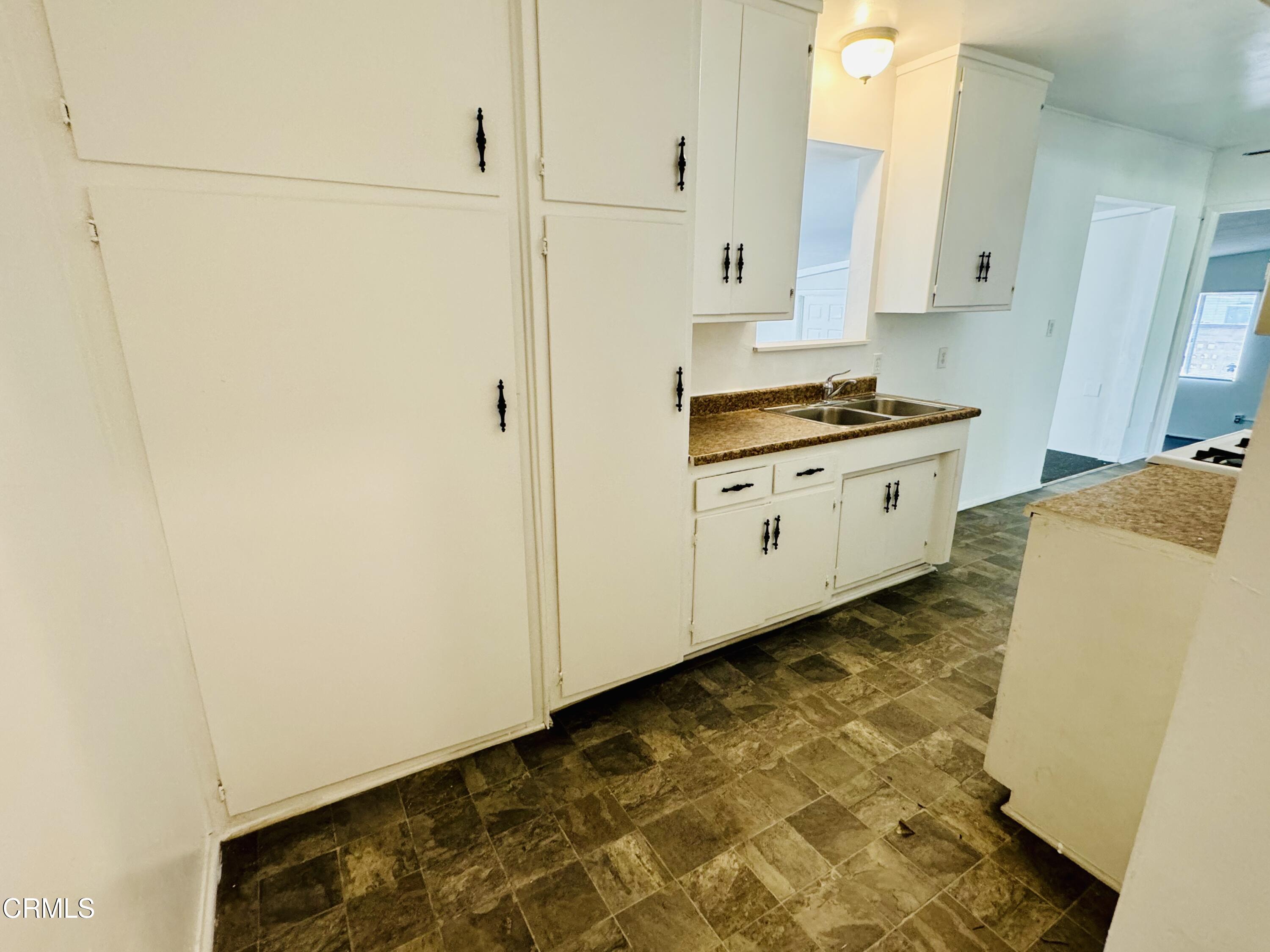 550 MacDonald Street Pasadena, CA 91103 - Photo 22 of 63 a kitchen with granite countertop white cabinets and white appliances