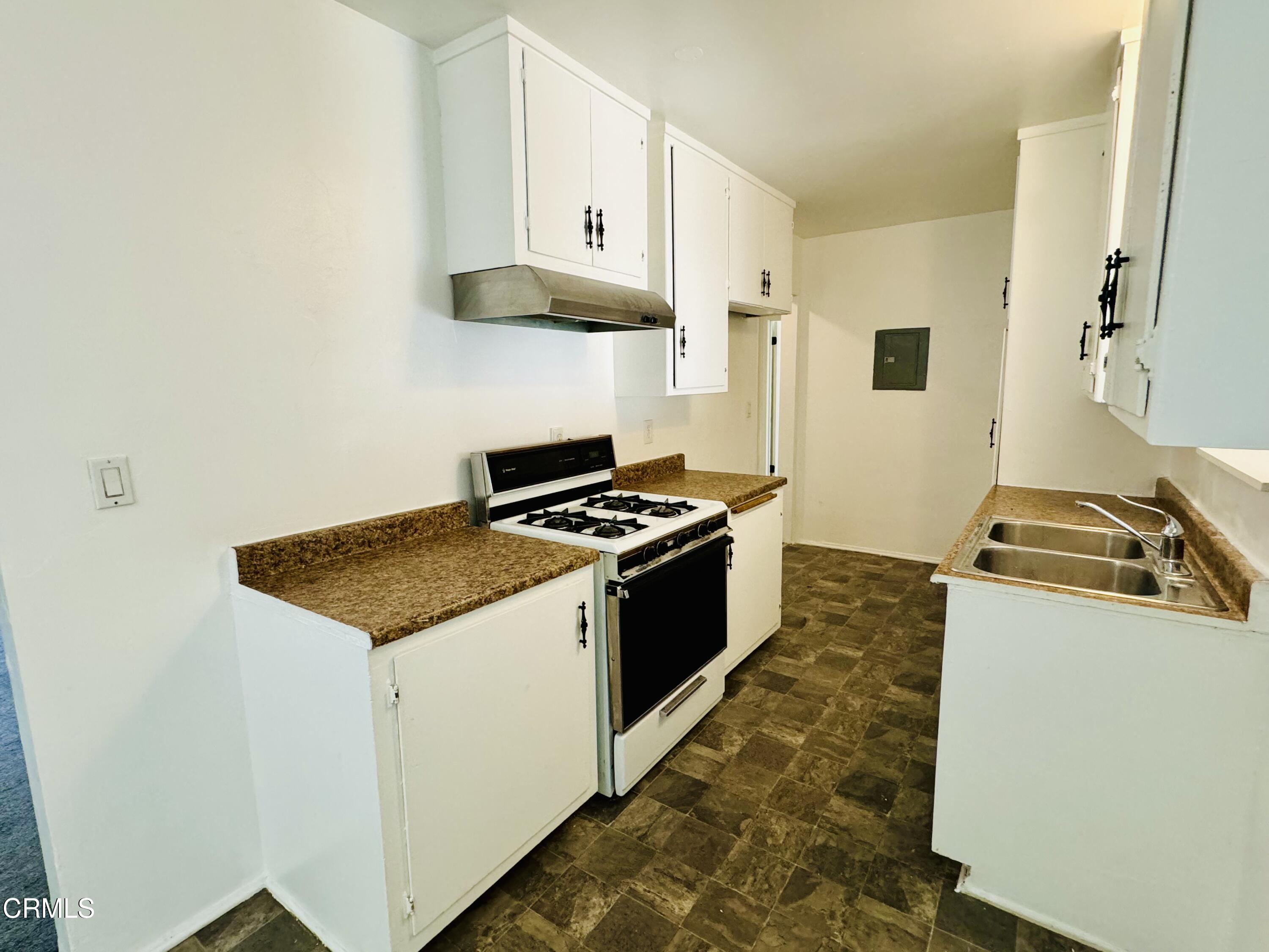 550 MacDonald Street Pasadena, CA 91103 - Photo 10 of 63 a kitchen with stainless steel appliances granite countertop a stove and a white refrigerator