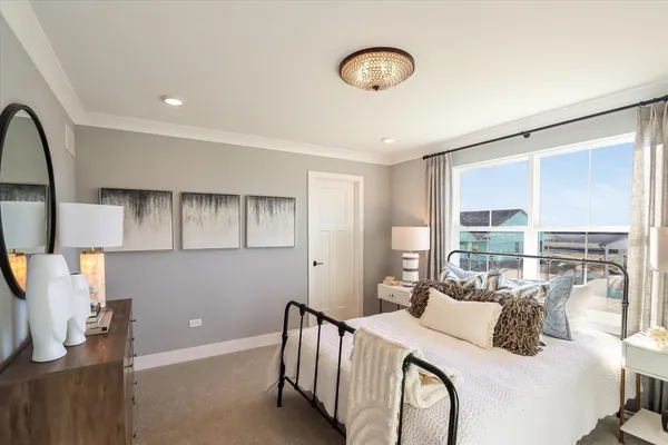 a bedroom with a bed and a large window