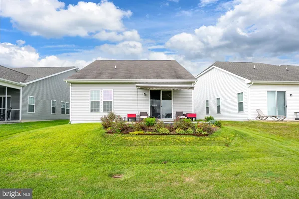 a front view of house with yard and outdoor seating