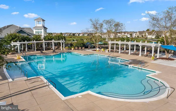 a view of a swimming pool with outdoor seating