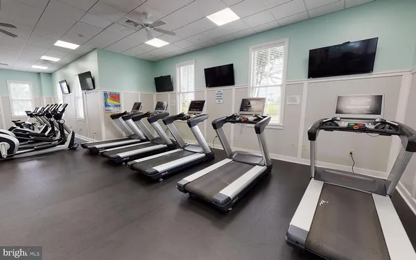 a room with gym equipment and a flat screen tv