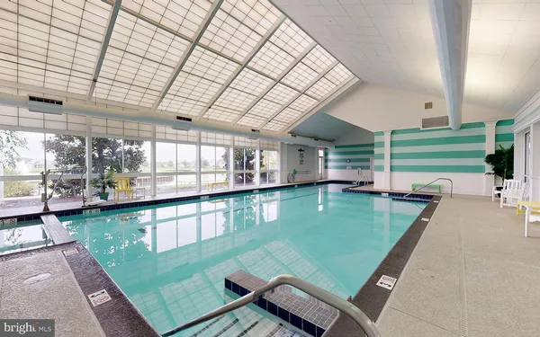 a view of a swimming pool with a outdoor seating