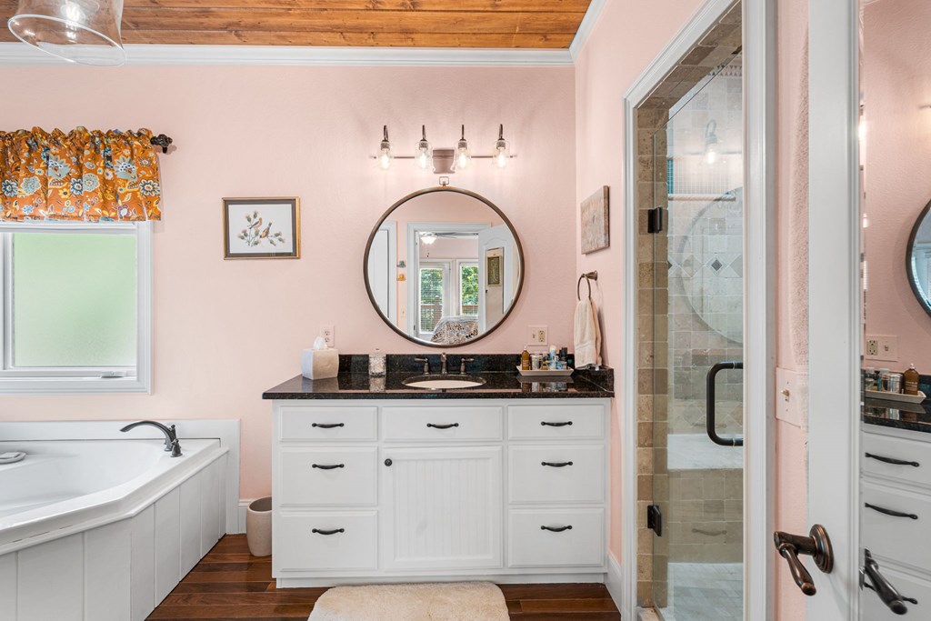 5125 Mineral Springs Road Young Harris, GA 30582 - Photo 32 of 62 a bathroom with a bathtub sink mirror and vanity