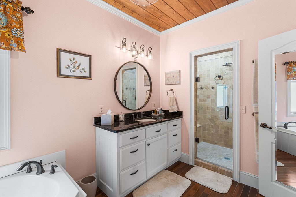 5125 Mineral Springs Road Young Harris, GA 30582 - Photo 33 of 62 a bathroom with a sink a mirror and a shower