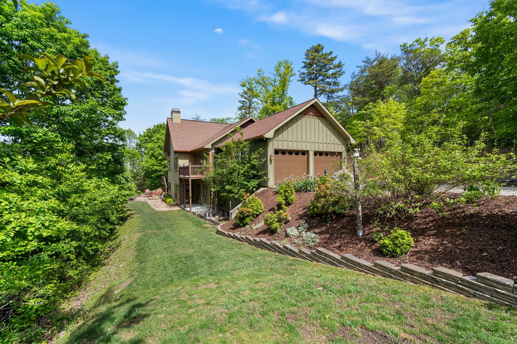5125 Mineral Springs Road Young Harris, GA 30582 - Photo 52 of 62 a front view of a house with a yard and potted plants