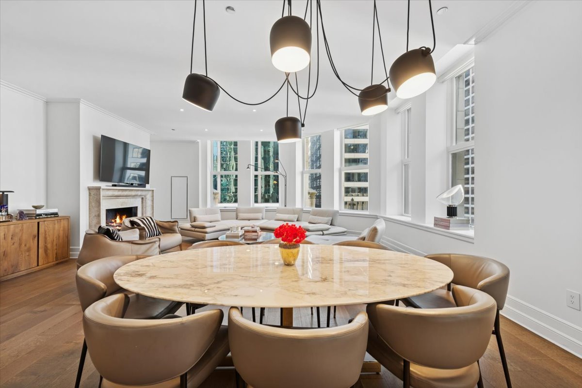 435 North Michigan Avenue, Unit 503 Chicago, IL 60611 - Photo 12 of 48 a dining room with couches chairs and a chandelier
