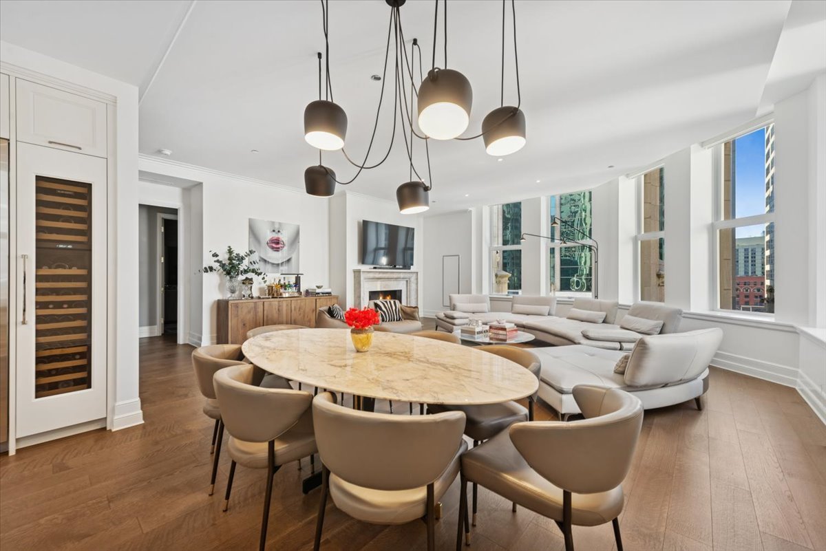 435 North Michigan Avenue, Unit 503 Chicago, IL 60611 - Photo 16 of 48 a dining room with wooden floor a chandelier a glass table and chairs