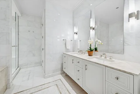 a spacious bathroom with double sink and shower