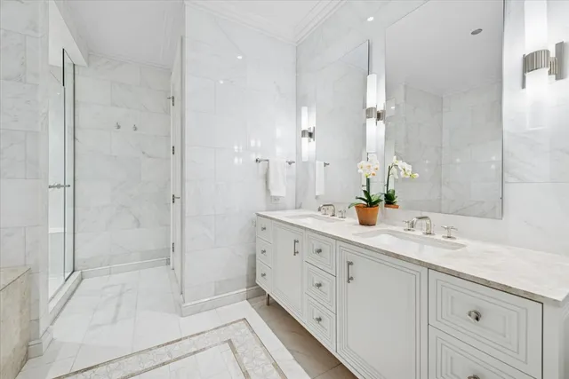 a spacious bathroom with double sink and shower