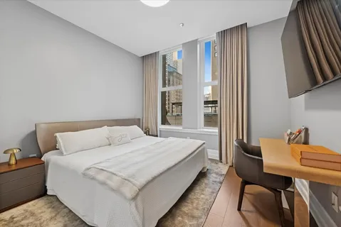 a living room with a bed furniture and a window